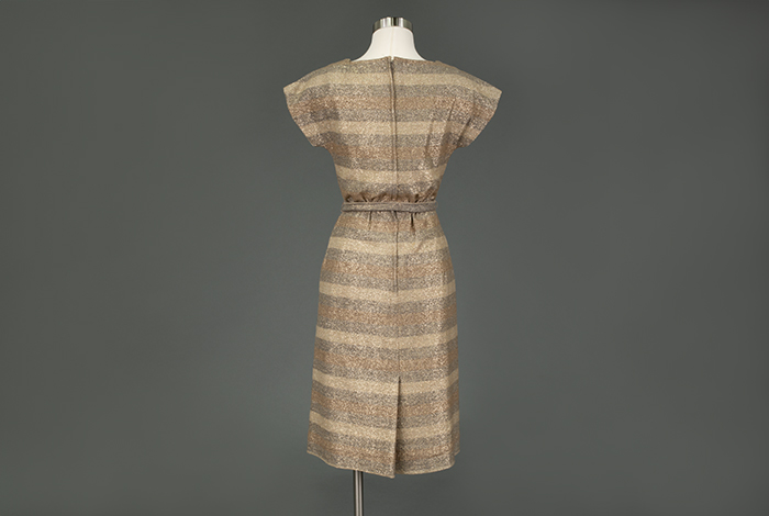 Image of Beige metallic dress, modeled in the Seattle World's Fair Fashion Pavilion, 1962